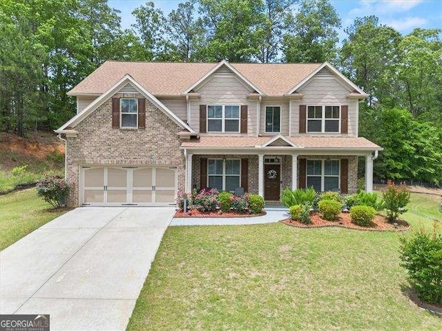 craftsman house with a garage, driveway, and a front yard