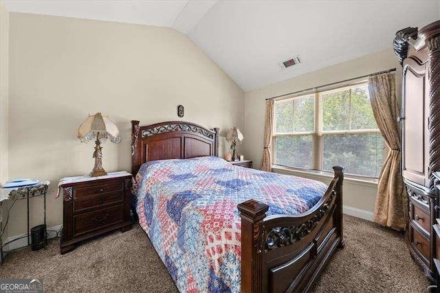 carpeted bedroom featuring vaulted ceiling and baseboards