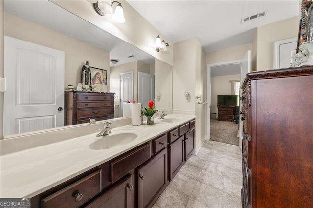 bathroom with double vanity and baseboards