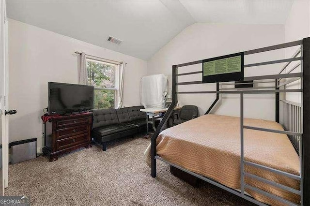 bedroom with vaulted ceiling and carpet floors