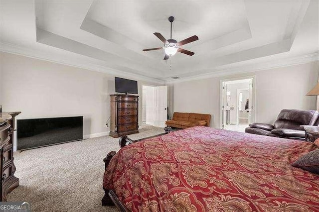 bedroom with a raised ceiling, carpet floors, crown molding, baseboards, and ceiling fan