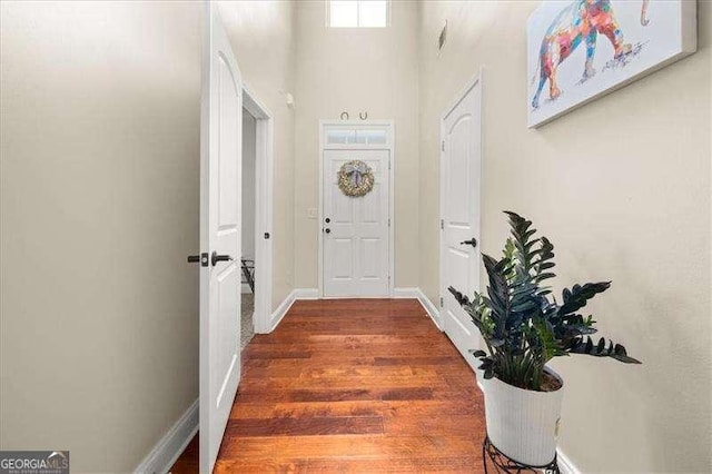 entryway featuring wood finished floors and baseboards