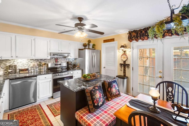 7 Stratford Dr, Athens, GA 30605 - kitchen featuring appliances with stainless steel finishes, under cabinet range hood, backsplash, ceiling fan, and white cabinetry
