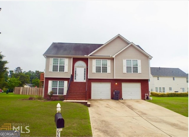 split foyer home with driveway, a garage, and brick siding