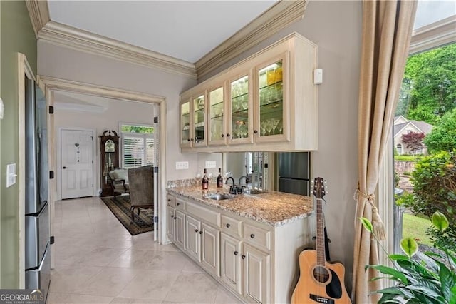 indoor wet bar with ornamental molding and light tile patterned flooring