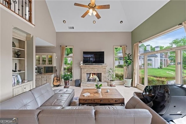 9325 Saint Georgen Cmn, Duluth, GA 30097 - living area featuring high vaulted ceiling, ceiling fan, a stone fireplace, built in shelves, and recessed lighting