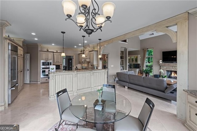 dining room featuring a chandelier, light tile patterned floors, recessed lighting, ornamental molding, and a fireplace