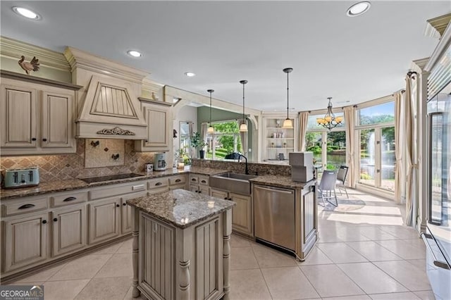kitchen with stainless steel dishwasher, a sink, a peninsula, black electric stovetop, and healthy amount of natural light