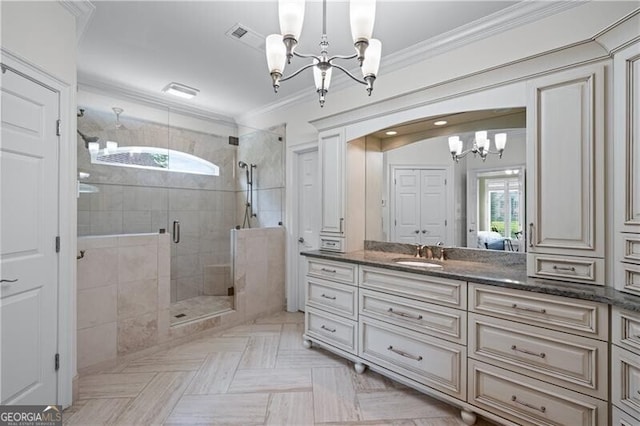 full bath featuring a chandelier, plenty of natural light, vanity, a shower stall, and ornamental molding