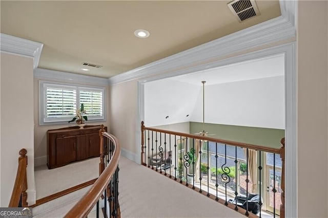 corridor featuring crown molding, recessed lighting, baseboards, carpet flooring, and an upstairs landing