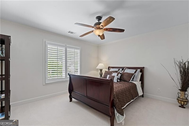 carpeted bedroom featuring baseboards, crown molding, and a ceiling fan