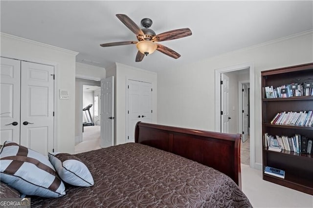 bedroom featuring ornamental molding, ceiling fan, and carpet