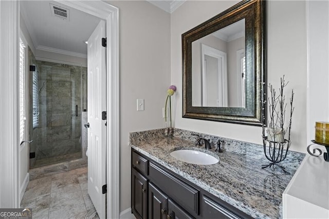 full bathroom with a shower stall, vanity, crown molding, and baseboards