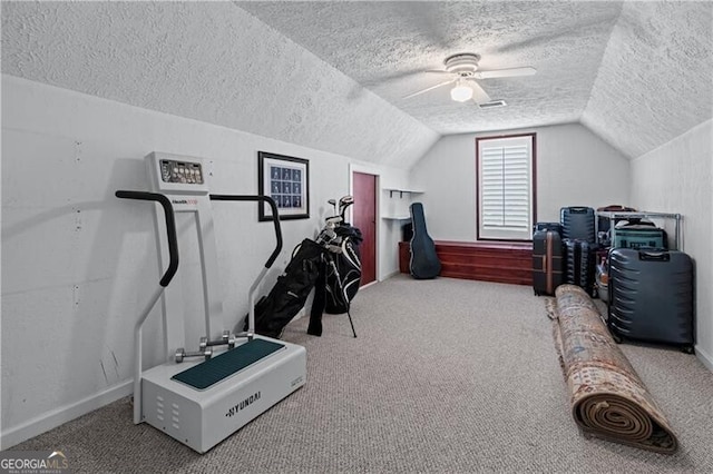 interior space with a textured ceiling, lofted ceiling, carpet floors, baseboards, and a ceiling fan