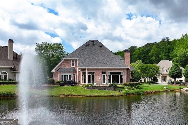 9325 Saint Georgen Cmn, Duluth, GA 30097 - back of house with a water view, a lawn, and brick siding