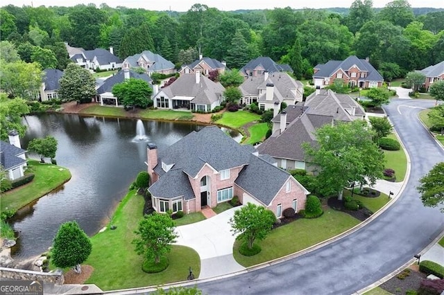 aerial perspective of suburban area with a nearby body of water