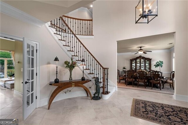 9325 Saint Georgen Cmn, Duluth, GA 30097 - tiled entrance foyer with french doors, stairs, a chandelier, a high ceiling, and a ceiling fan