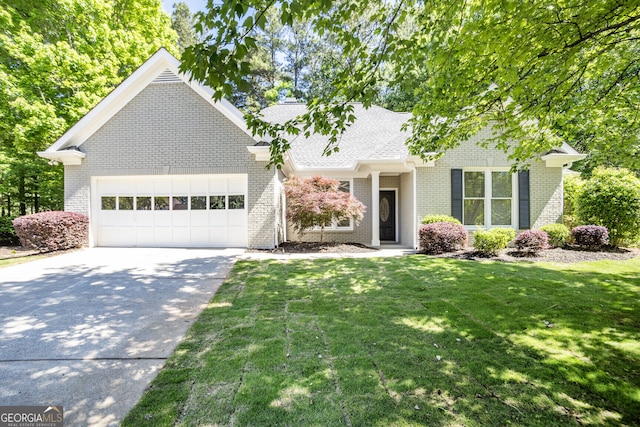 view of front facade featuring a garage, concrete driveway, brick siding, a front lawn, and roof with shingles