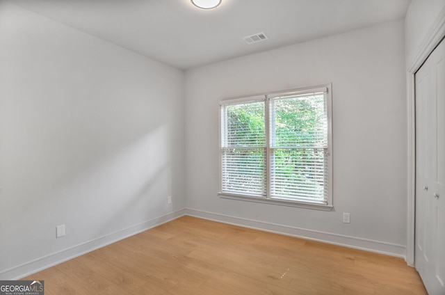 empty room with light wood-style flooring and baseboards