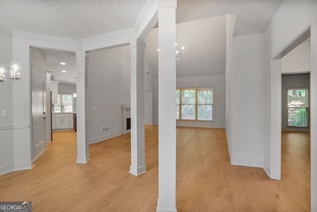entryway featuring ornate columns, plenty of natural light, light wood finished floors, baseboards, and recessed lighting