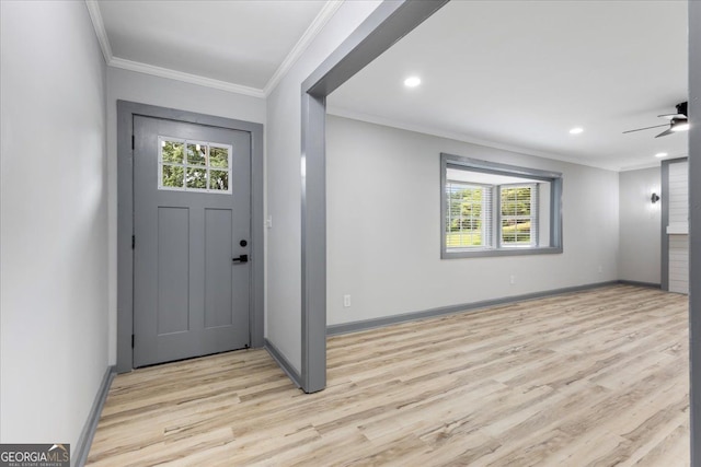 entrance foyer with healthy amount of natural light, light wood-type flooring, crown molding, baseboards, and a ceiling fan