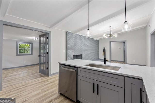 kitchen with stainless steel dishwasher, a sink, gray cabinets, light stone counters, and pendant lighting