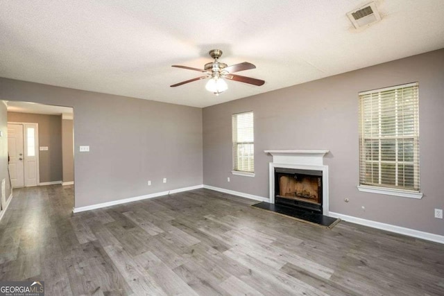 3730 Warriors Path, Decatur, GA 30034 - unfurnished living room featuring ceiling fan, a fireplace, wood finished floors, and healthy amount of natural light