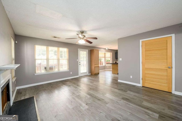 3730 Warriors Path, Decatur, GA 30034 - unfurnished living room with ceiling fan, a fireplace, wood finished floors, a textured ceiling, and baseboards