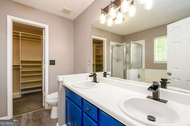 3730 Warriors Path, Decatur, GA 30034 - bathroom with wood finished floors, a shower stall, toilet, double vanity, and a chandelier