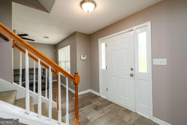3730 Warriors Path, Decatur, GA 30034 - entryway featuring a textured ceiling, wood finished floors, stairway, and baseboards