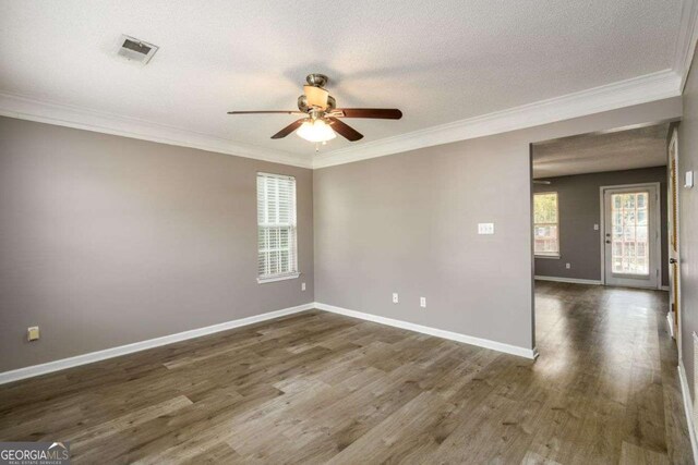 3730 Warriors Path, Decatur, GA 30034 - empty room featuring healthy amount of natural light, a ceiling fan, crown molding, dark wood-style flooring, and baseboards