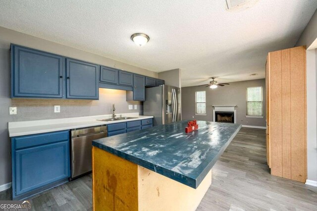3730 Warriors Path, Decatur, GA 30034 - kitchen with stainless steel appliances, blue cabinets, a ceiling fan, a kitchen island, and a sink