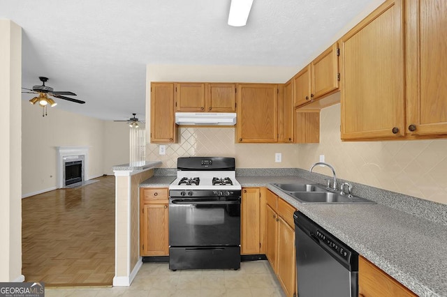 6359 Wedgeview Dr, Tucker, GA 30084 - kitchen with range with gas stovetop, stainless steel dishwasher, a sink, under cabinet range hood, and ceiling fan