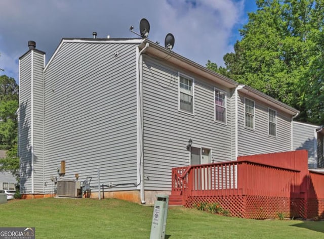 6359 Wedgeview Dr, Tucker, GA 30084 - back of property with a lawn, a deck, central air condition unit, and a chimney