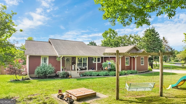 739 Rockford Creek Rd, Clarkesville, GA 30523 - view of front of property with a front lawn, covered porch, roof with shingles, and a playground