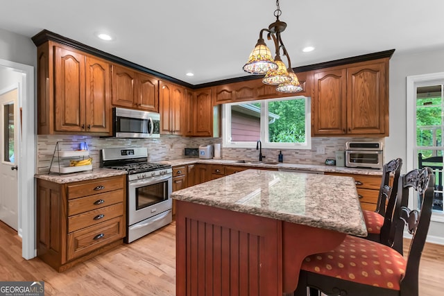 739 Rockford Creek Rd, Clarkesville, GA 30523 - kitchen with stainless steel appliances, light wood-type flooring, light stone counters, decorative backsplash, and decorative light fixtures