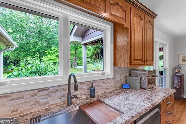 739 Rockford Creek Rd, Clarkesville, GA 30523 - kitchen with tasteful backsplash, a sink, and light stone countertops