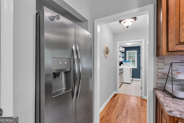 739 Rockford Creek Rd, Clarkesville, GA 30523 - kitchen with stainless steel fridge, brown cabinets, tasteful backsplash, and light wood-type flooring