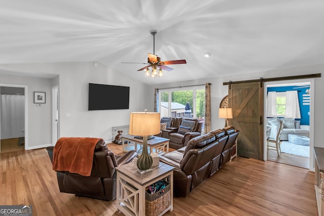 739 Rockford Creek Rd, Clarkesville, GA 30523 - living room with a barn door, lofted ceiling, wood finished floors, and a ceiling fan