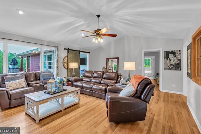739 Rockford Creek Rd, Clarkesville, GA 30523 - living area featuring vaulted ceiling, a barn door, light wood-style floors, ceiling fan, and baseboards