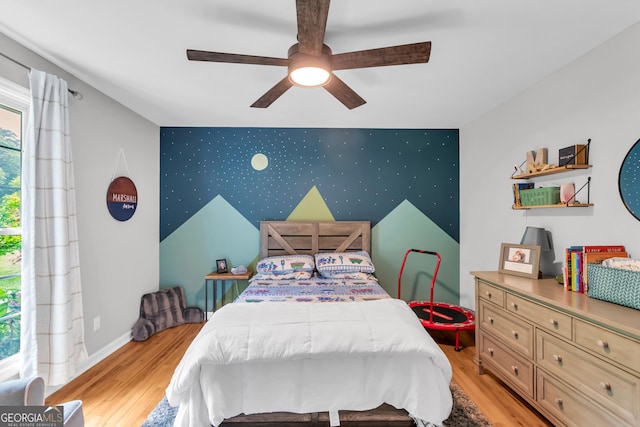 739 Rockford Creek Rd, Clarkesville, GA 30523 - bedroom with an accent wall, wallpapered walls, light wood-style floors, baseboards, and ceiling fan