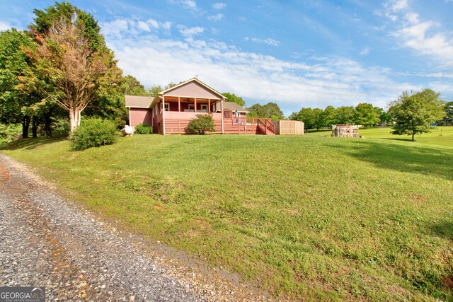 739 Rockford Creek Rd, Clarkesville, GA 30523 - view of front of home with a front lawn, a sunroom, gravel driveway, a wooden deck, and stairs