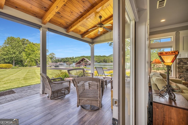 wooden deck featuring a water view, a yard, ceiling fan, an outdoor living space, and view of scattered trees