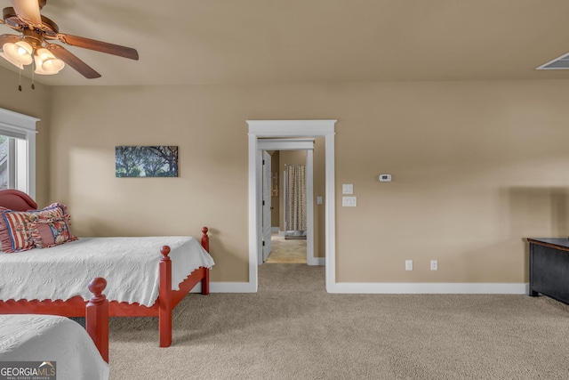 carpeted bedroom with baseboards and ceiling fan