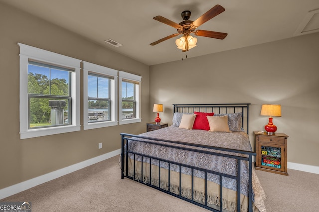 carpeted bedroom with baseboards and a ceiling fan