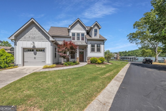 craftsman inspired home featuring board and batten siding, driveway, a garage, a front yard, and roof with shingles