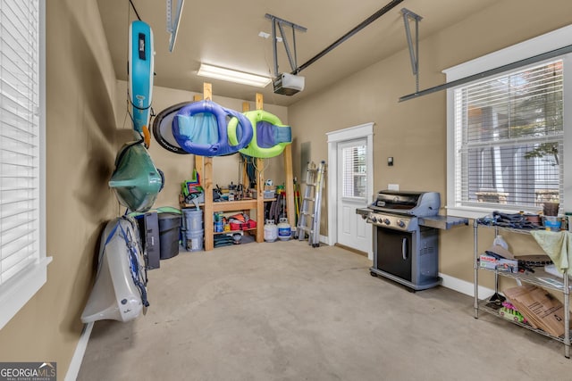 garage featuring a garage door opener and baseboards