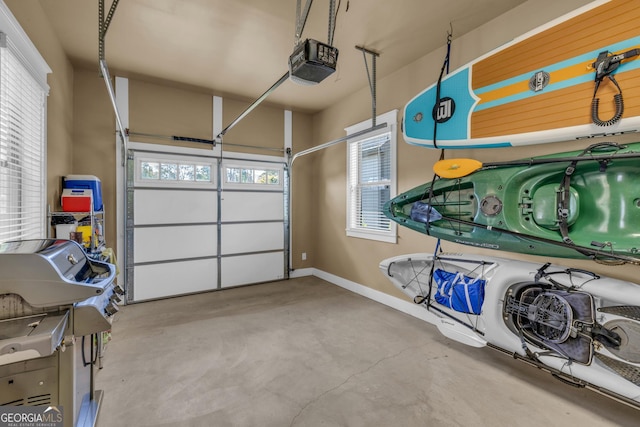 garage featuring a garage door opener and baseboards