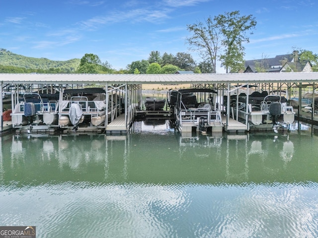 dock area featuring boat lift and a water view