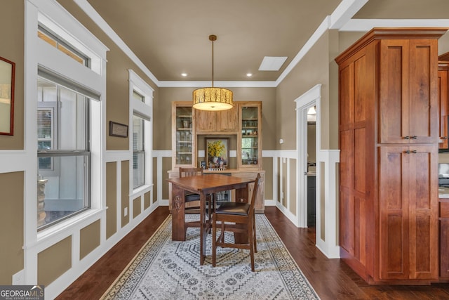 dining room featuring dark wood-style flooring, crown molding, and recessed lighting